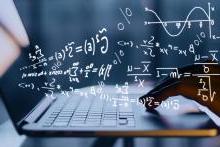 Mathematical equations floating over a student's laptop